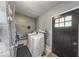 The laundry room features a modern washer and dryer with a convenient exterior door at 608 W 600 N, Fortville, IN 46040