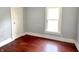Bedroom with a window, simple design, and wood flooring at 613 N Tacoma Ave, Indianapolis, IN 46201