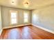 Bedroom featuring two windows, natural light, and wood flooring at 613 N Tacoma Ave, Indianapolis, IN 46201