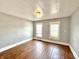 Bedroom showing wood floors, a window with blinds and neutral paint at 613 N Tacoma Ave, Indianapolis, IN 46201