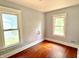 Bedroom featuring two windows and wood flooring at 613 N Tacoma Ave, Indianapolis, IN 46201