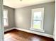 Bedroom featuring two windows and wood floors at 613 N Tacoma Ave, Indianapolis, IN 46201