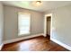Bedroom featuring neutral walls, wood floor, window with blinds and an open closet at 613 N Tacoma Ave, Indianapolis, IN 46201