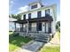 Two-story home featuring a covered front porch and landscaping at 613 N Tacoma Ave, Indianapolis, IN 46201