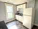 The kitchen features a window with a view, white cabinets and ample counter space at 613 N Tacoma Ave, Indianapolis, IN 46201