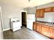 Efficient kitchen layout with white appliances and gray flooring at 613 N Tacoma Ave, Indianapolis, IN 46201