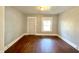This living room features hardwood floors, natural light, and a neutral color scheme at 613 N Tacoma Ave, Indianapolis, IN 46201