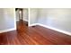 Living room showing hardwood floors, neutral paint, and arched doorway at 613 N Tacoma Ave, Indianapolis, IN 46201
