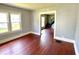 Living room with hardwood floors, neutral paint, view of windows and stairway at 613 N Tacoma Ave, Indianapolis, IN 46201