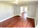 Living room with hardwood floors, neutral paint, and a view of another room at 613 N Tacoma Ave, Indianapolis, IN 46201