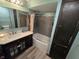 Cozy bathroom featuring a tub with gray subway tile surround, dark wood vanity, and wood look floors at 627 Plum St, Noblesville, IN 46060