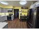 Bright eat-in kitchen with gray cabinetry, stainless steel appliances, and wood-look flooring at 627 Plum St, Noblesville, IN 46060