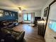 Comfortable living room with a large leather sofa, ceiling fan, and bright natural light at 627 Plum St, Noblesville, IN 46060