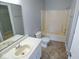 Bright bathroom featuring a shower-tub combo and single sink vanity at 6412 Cradle River Dr, Indianapolis, IN 46221
