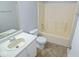 Bathroom featuring vinyl floors, white cabinets and a standard shower and bath at 6412 Cradle River Dr, Indianapolis, IN 46221