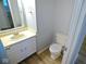 Compact half bathroom with a single vanity, toilet and neutral paint at 6412 Cradle River Dr, Indianapolis, IN 46221