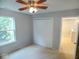 Bedroom featuring neutral walls, carpet, closet, and a bright window at 6412 Cradle River Dr, Indianapolis, IN 46221