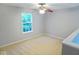 Bedroom featuring neutral walls, carpet, a ceiling fan, and a bright window at 6412 Cradle River Dr, Indianapolis, IN 46221