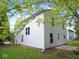 Side view of a two-story home with white siding and green lawn at 6412 Cradle River Dr, Indianapolis, IN 46221