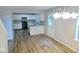 An open concept kitchen and dining area with all white cabinets and black appliances at 6412 Cradle River Dr, Indianapolis, IN 46221