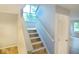 Carpeted stairs leading to the second floor with natural light from the window at 6412 Cradle River Dr, Indianapolis, IN 46221
