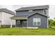 Home featuring a patio and siding exterior, with a lush green lawn and garden bed at 6537 Seabiscuit Rd, Whitestown, IN 46075