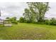 Green backyard with a garden, view of trees and a charming outdoor seating area at 6537 Seabiscuit Rd, Whitestown, IN 46075