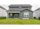 Backyard of home featuring a covered patio, sliding glass doors, and a garden bed at 6537 Seabiscuit Rd, Whitestown, IN 46075
