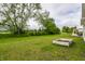 Lush backyard featuring a garden bed with a variety of vegetation and mature trees at 6537 Seabiscuit Rd, Whitestown, IN 46075