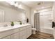 Well-lit bathroom with a double vanity, shower and tub combo, and modern fixtures at 6537 Seabiscuit Rd, Whitestown, IN 46075