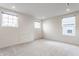 Bright, empty bedroom with three windows, neutral walls and carpet, and ample light at 6537 Seabiscuit Rd, Whitestown, IN 46075