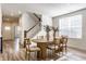 Dining room with modern furniture, hardwood floors, and large windows at 6537 Seabiscuit Rd, Whitestown, IN 46075