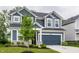 Two-story home with blue siding, a two-car garage, and landscaping at 6537 Seabiscuit Rd, Whitestown, IN 46075