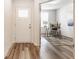 Bright foyer with hardwood floors, leading to a home office with modern furnishings at 6537 Seabiscuit Rd, Whitestown, IN 46075