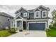 Traditional two-story home with a two-car garage and inviting front lawn at 6537 Seabiscuit Rd, Whitestown, IN 46075