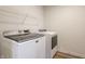 Functional laundry room with modern washer and dryer, plus shelving for storage at 6537 Seabiscuit Rd, Whitestown, IN 46075