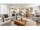 Open concept living room with modern furnishings connecting to a bright kitchen at 6537 Seabiscuit Rd, Whitestown, IN 46075