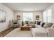 Spacious living room with large windows, modern furnishings, and plush seating at 6537 Seabiscuit Rd, Whitestown, IN 46075