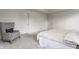 Bright main bedroom showcases neutral walls and carpet along with a comfortable chair at 6537 Seabiscuit Rd, Whitestown, IN 46075
