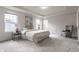 Spacious main bedroom featuring tray ceilings, neutral decor, and a comfortable sitting area at 6537 Seabiscuit Rd, Whitestown, IN 46075