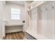 Mudroom featuring a storage cubby with hooks, a built in desk, and wood-look floors at 6537 Seabiscuit Rd, Whitestown, IN 46075