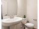 Powder room features a pedestal sink, a toilet, and wood-look flooring at 6537 Seabiscuit Rd, Whitestown, IN 46075