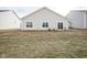 Backyard features a lawn, and sliding glass doors leading to the home's interior at 6608 W Shoreline Ct, Greenfield, IN 46140