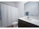 Bathroom features a shower with curtain, a white sink and vanity, a large mirror, and a toilet at 6608 W Shoreline Ct, Greenfield, IN 46140