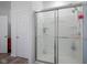 Bathroom featuring a glass-enclosed shower with white tile surround at 6608 W Shoreline Ct, Greenfield, IN 46140