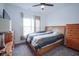 Bedroom with carpet flooring, ceiling fan, a large window, and wood furniture at 6608 W Shoreline Ct, Greenfield, IN 46140