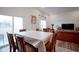 Bright dining room featuring hardwood floors, a sliding glass door to patio, and views to the living room at 6608 W Shoreline Ct, Greenfield, IN 46140