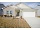 Charming single-Gathering home featuring a two-car garage and well-maintained front yard at 6608 W Shoreline Ct, Greenfield, IN 46140