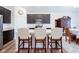 Stylish kitchen featuring dark cabinetry, quartz countertops, and island seating for three at 6608 W Shoreline Ct, Greenfield, IN 46140