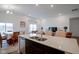 Spacious kitchen with a large center island, stainless steel sink, and dining area beyond at 6608 W Shoreline Ct, Greenfield, IN 46140